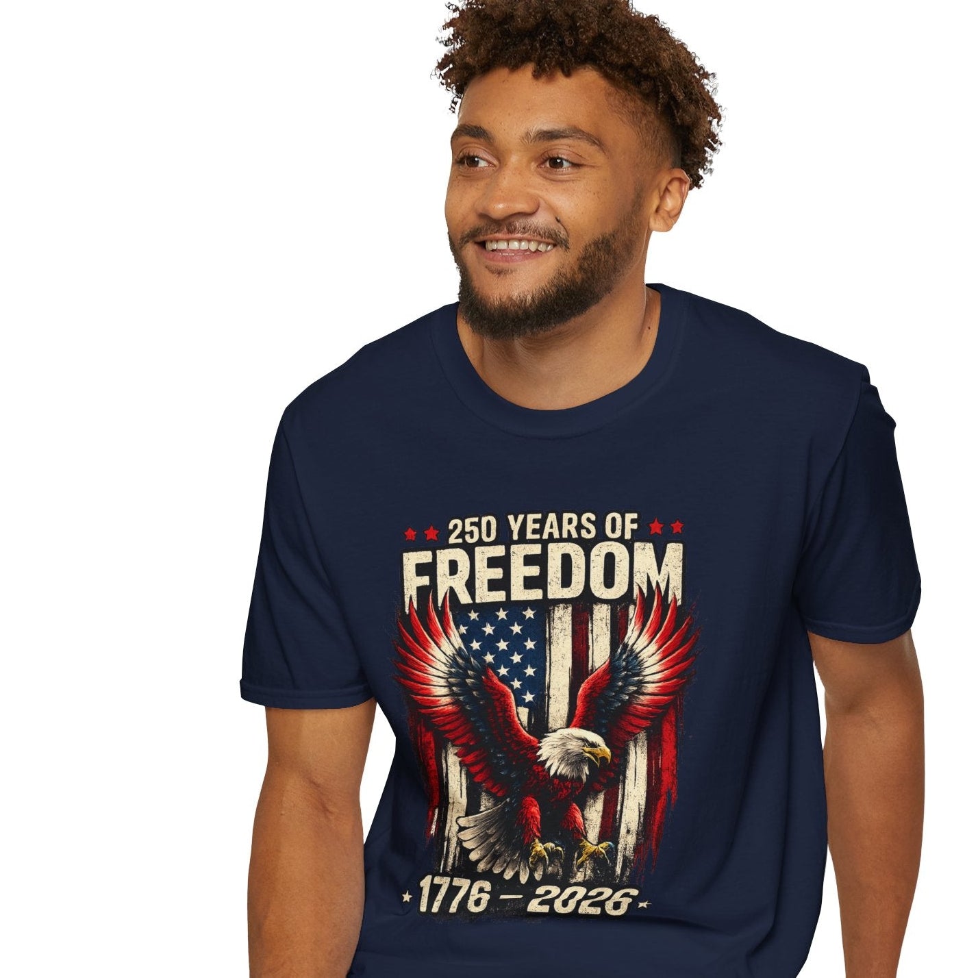 Man wearing a navy blue t-shirt with '250 Years of Freedom' design, sitting on a white stool against a white background.