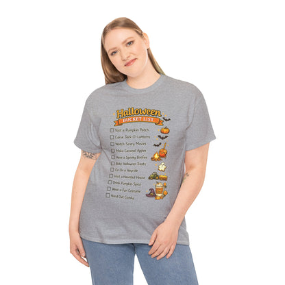 A woman modeling a heather gray t-shirt with a 'Halloween Cheat Sheet' checklist graphic on the front, paired with blue jeans against a plain white background.