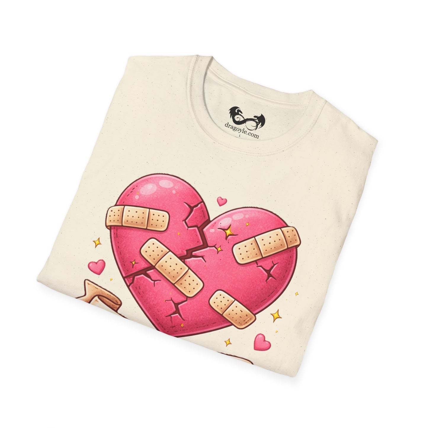 Folded t-shirt with a pink heart design and bandages on a white background