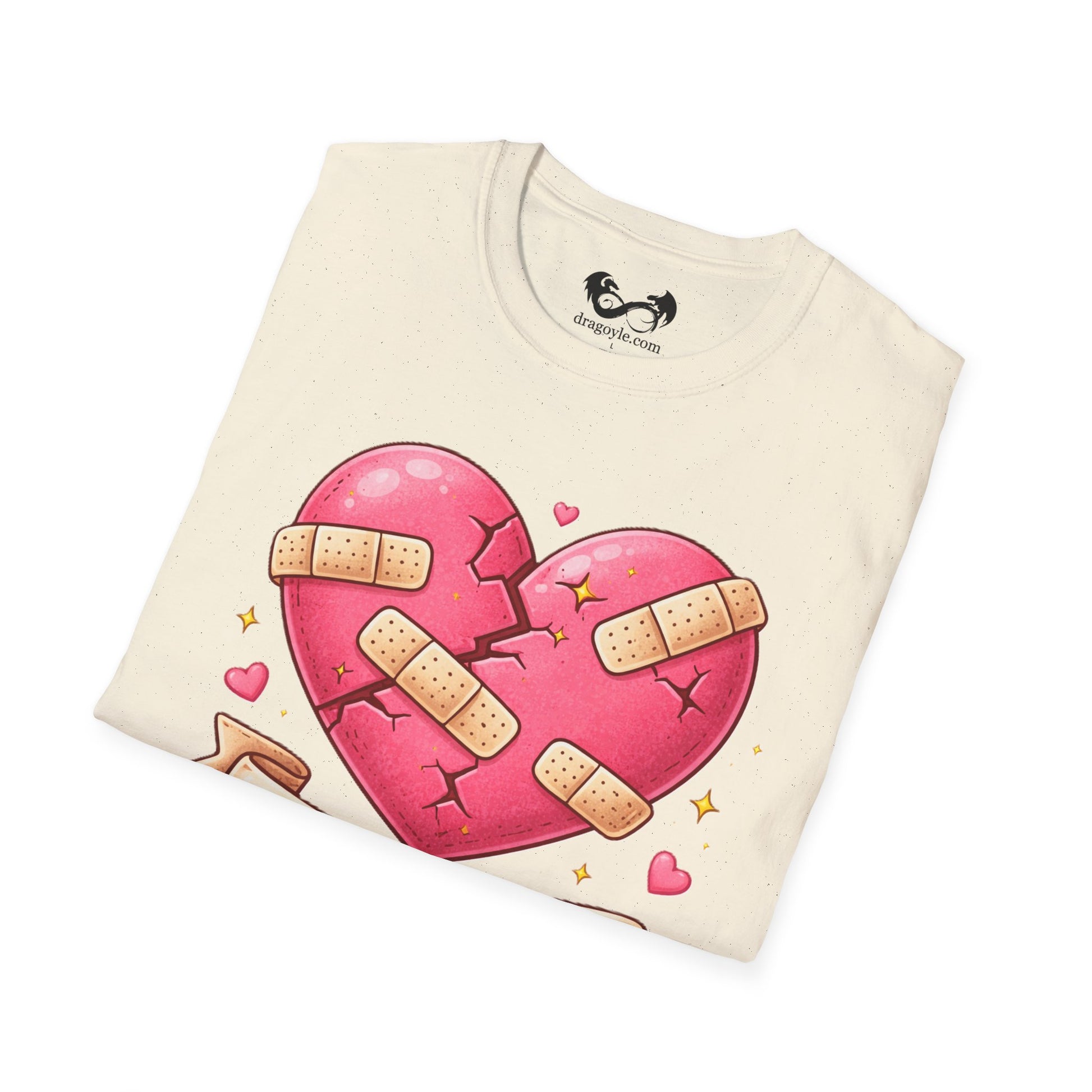 Folded t-shirt with a pink heart design and bandages on a white background