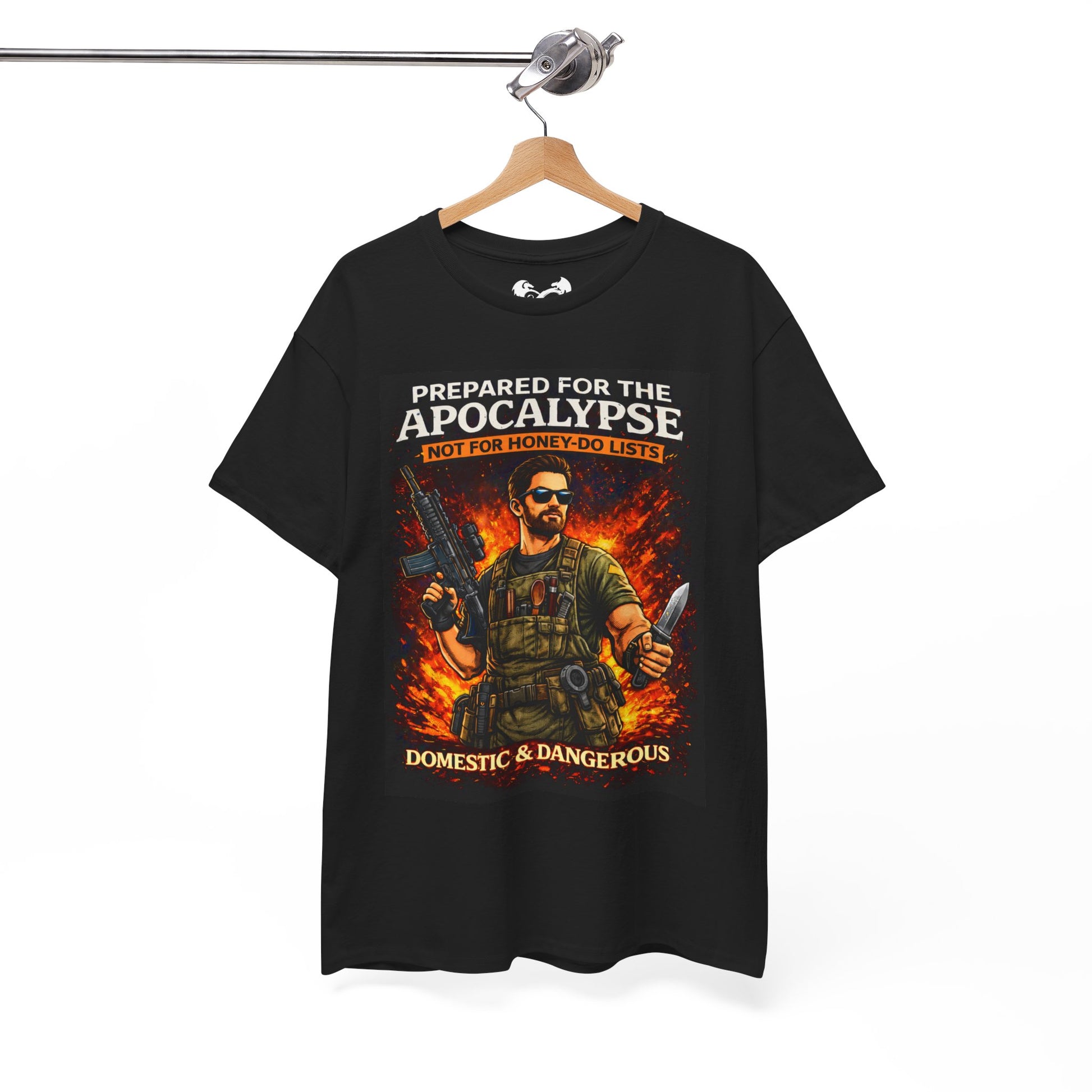Black t-shirt with graphic design of a person holding weapons and text 'Prepared for the Apocalypse Not for Honey Do Lists Domestic & Dangerous' on a hanger.