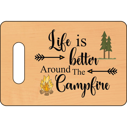 Wooden cutting board with 'Life is better around the campfire' text and camping-themed graphics.