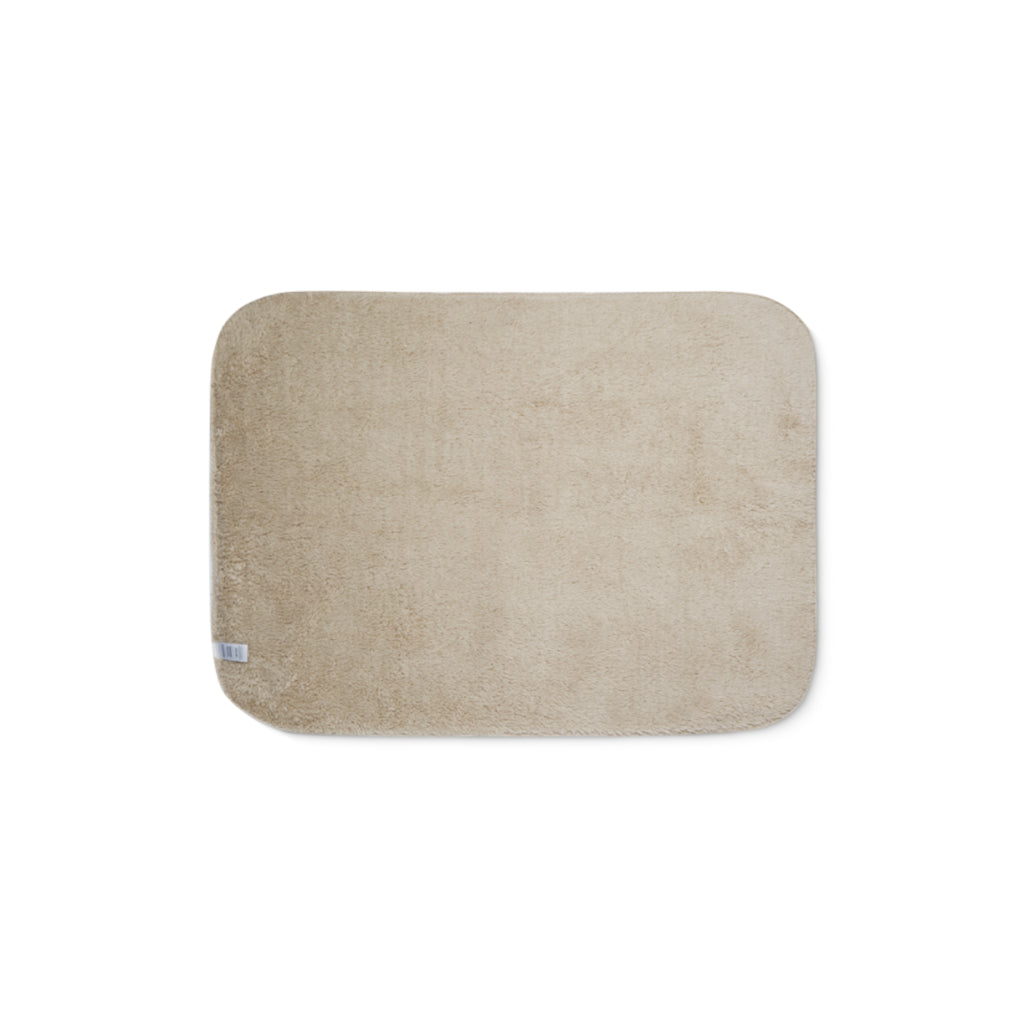Beige bath mat on a white background