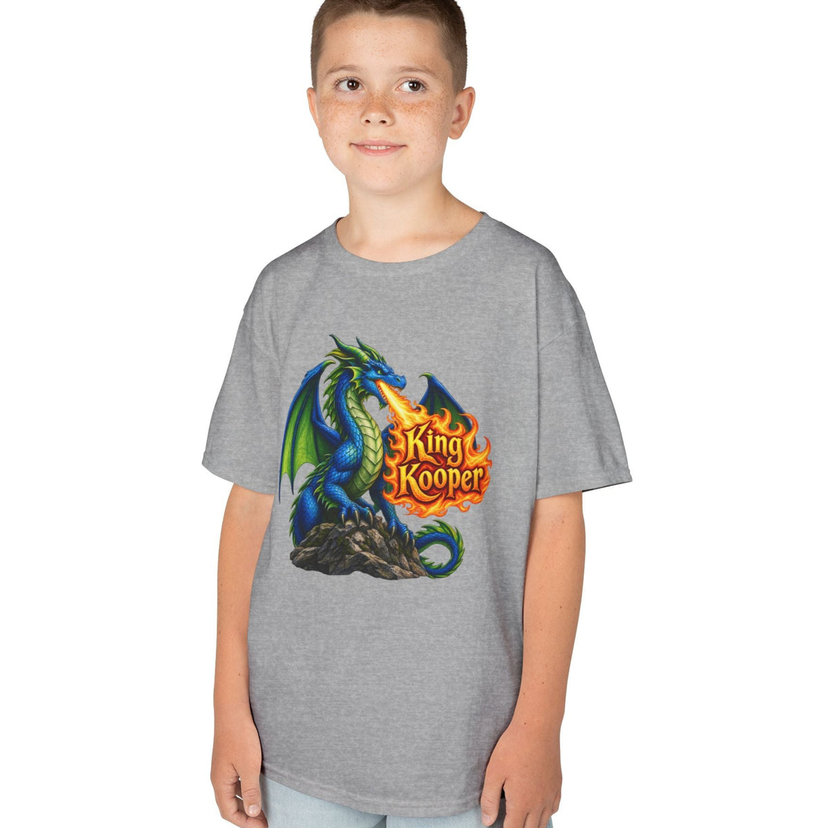 A child wearing a heather gray short-sleeve t-shirt with a colorful graphic of a blue and green dragon breathing fire next to the text 'King Kooper'.