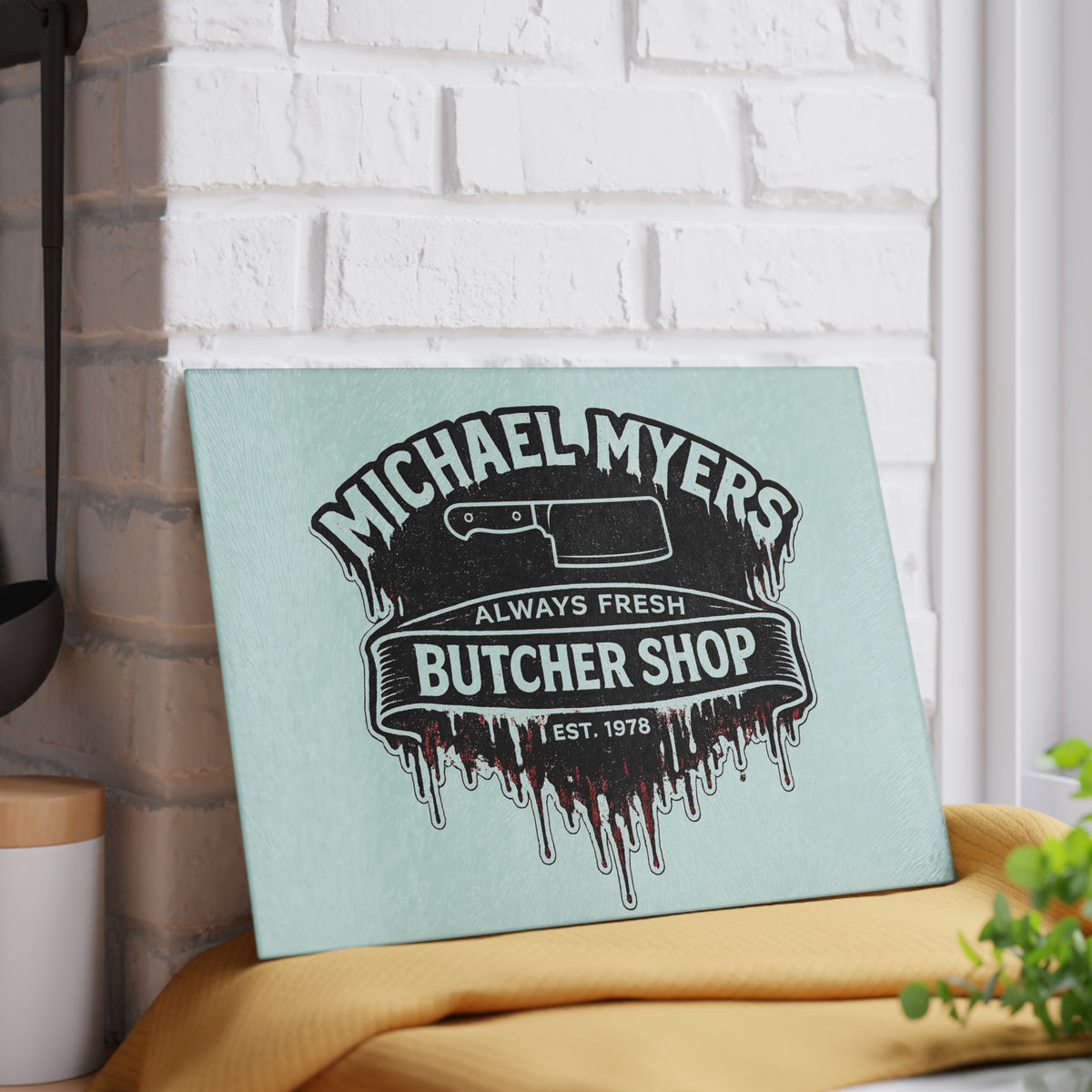 Bring a chilling touch of horror-inspired style to your kitchen with the Michael Myers Butcher Shop Glass Cutting Board. Designed for fans of classic slasher movies and spooky kitchen décor, this bold cutting board combines everyday functionality with a dark, Halloween-inspired aesthetic.