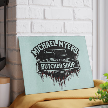 Bring a chilling touch of horror-inspired style to your kitchen with the Michael Myers Butcher Shop Glass Cutting Board. Designed for fans of classic slasher movies and spooky kitchen décor, this bold cutting board combines everyday functionality with a dark, Halloween-inspired aesthetic.