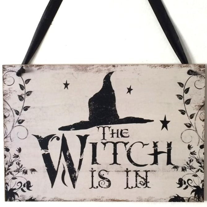 Fly away to the dark side of Halloween décor with this enchanting "The Witch Is In" rustic wooden plaque! This quirky decoration is sure to spark conversations and cast a spell over trick-or-treaters. Come, come! The Witch Is In!  On the back side it says "Out of Candy".