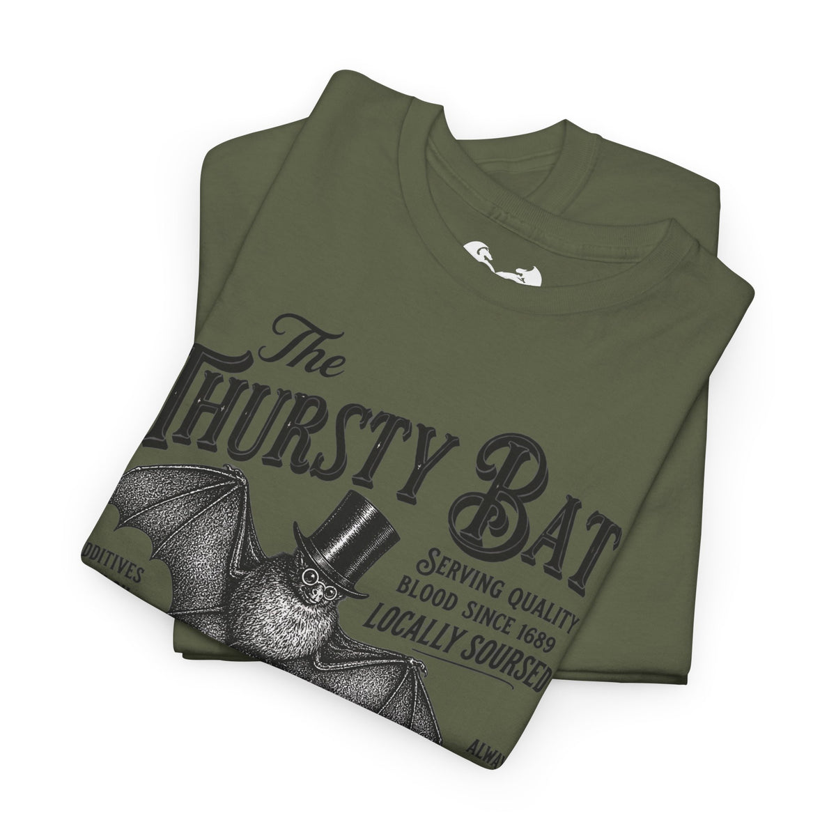 An olive green folded t-shirt featuring a dark gray graphic of a bat wearing a top hat with the text 'The THIRSTY BAT' and 'Serving quality blood since 1689 LOCALLY SOURCED'.