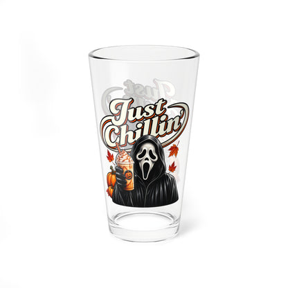 A clear pint glass featuring a Halloween-themed graphic of Ghostface holding an iced coffee with a pumpkin, under the text 'Just Chillin'', on a white background.