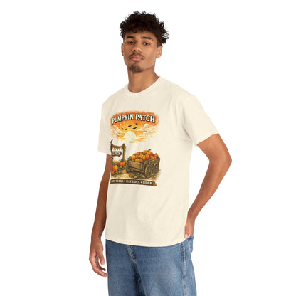 A man wearing a cream-colored graphic t-shirt with a 'Pumpkin Patch' autumn harvest design, paired with blue jeans, photographed against a solid white background.