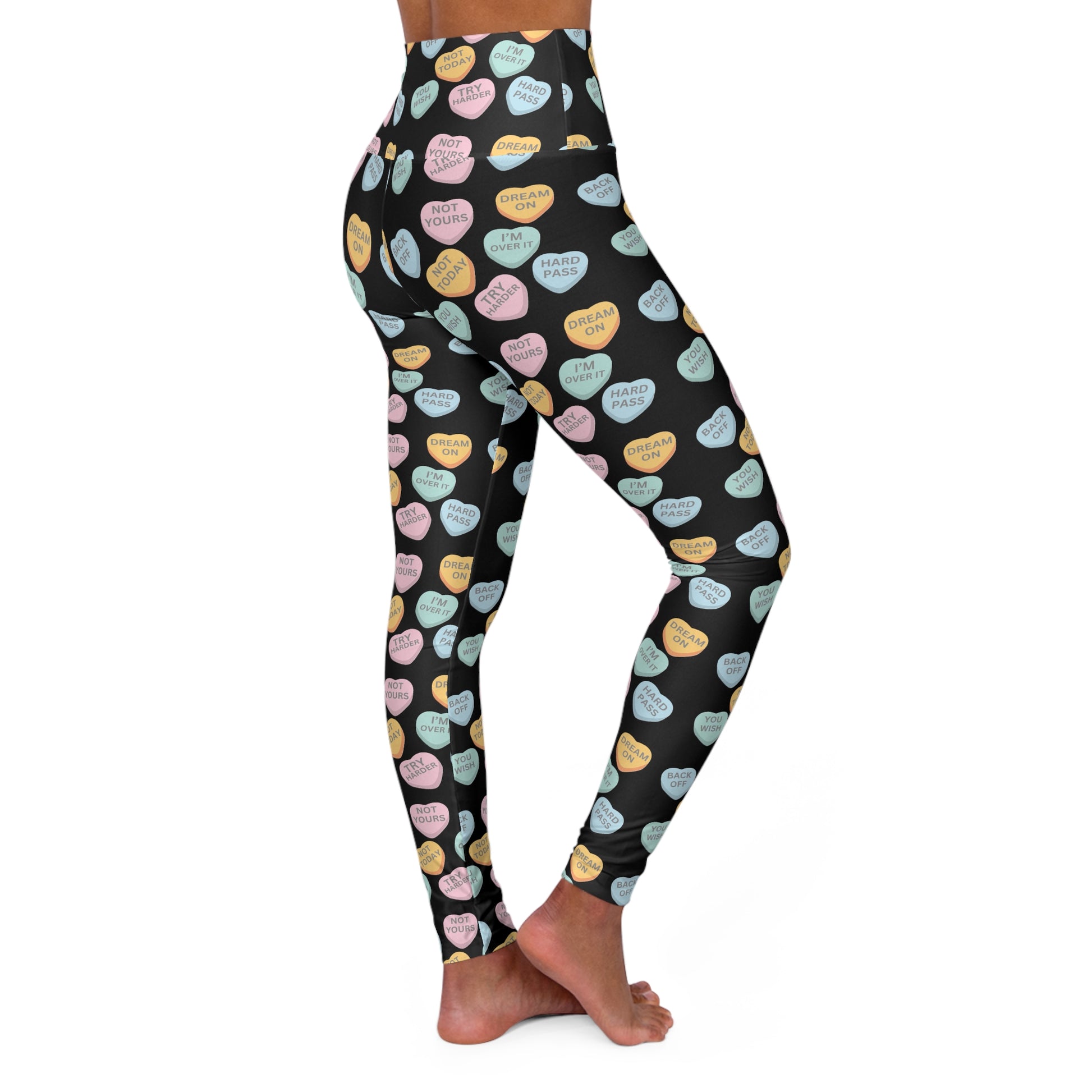 Leggings with colorful candy heart pattern on a black background