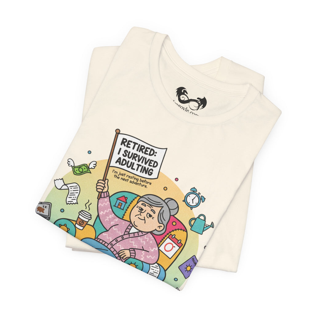 Folded t-shirt with a colorful graphic and text 'Retired: I Survived Adulting' on a white background