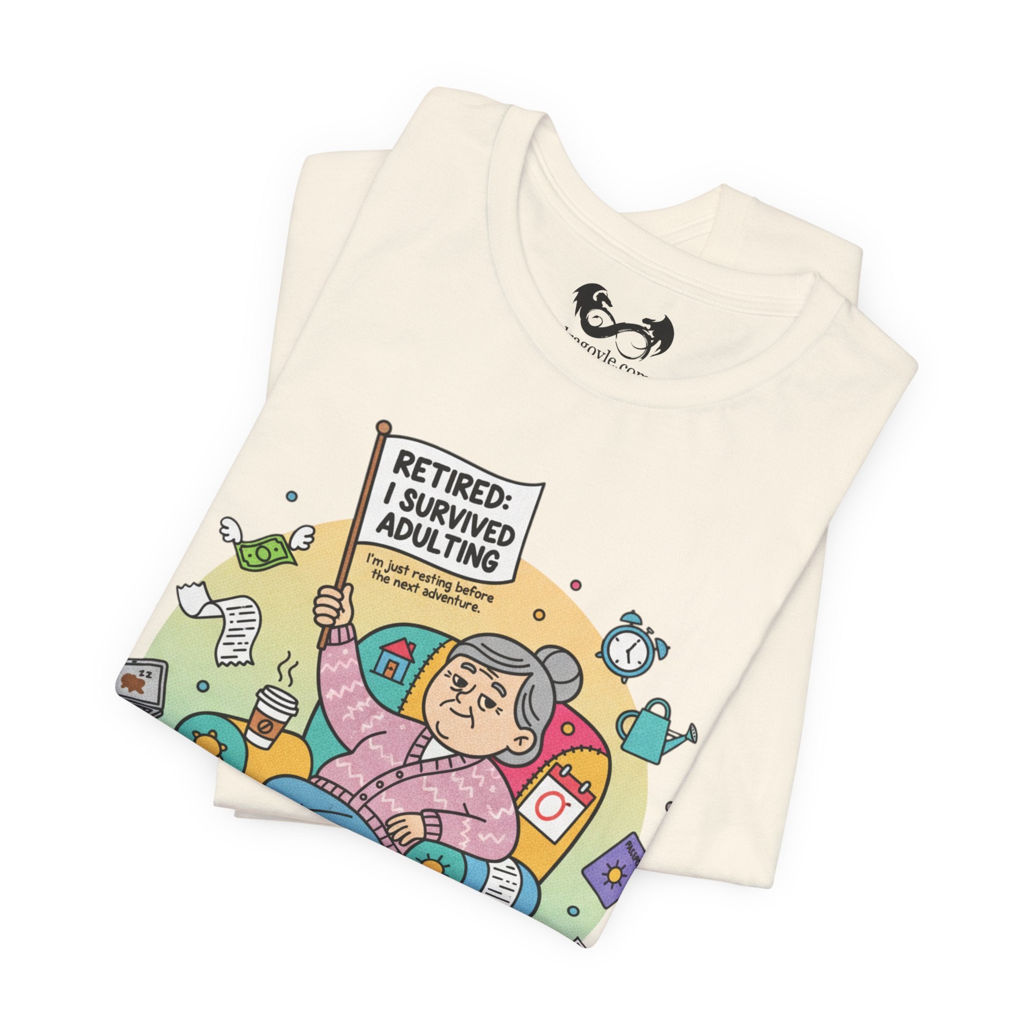 Folded t-shirt with a colorful graphic and text 'Retired: I Survived Adulting' on a white background