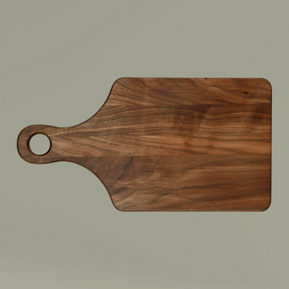 Wooden cutting board with a handle on a beige background