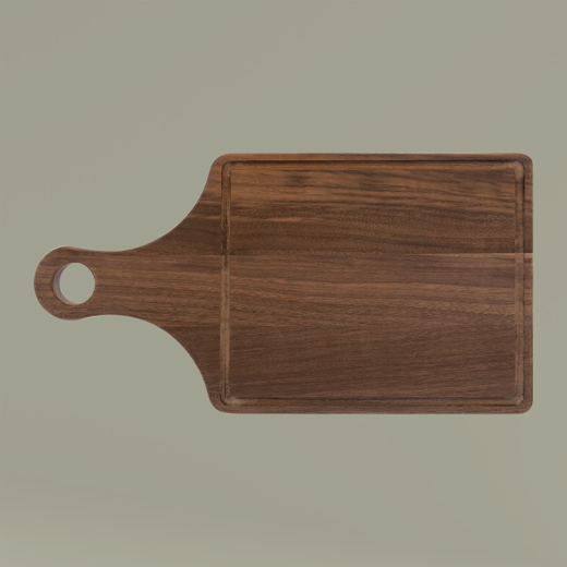 Wooden cutting board with handle on a beige background