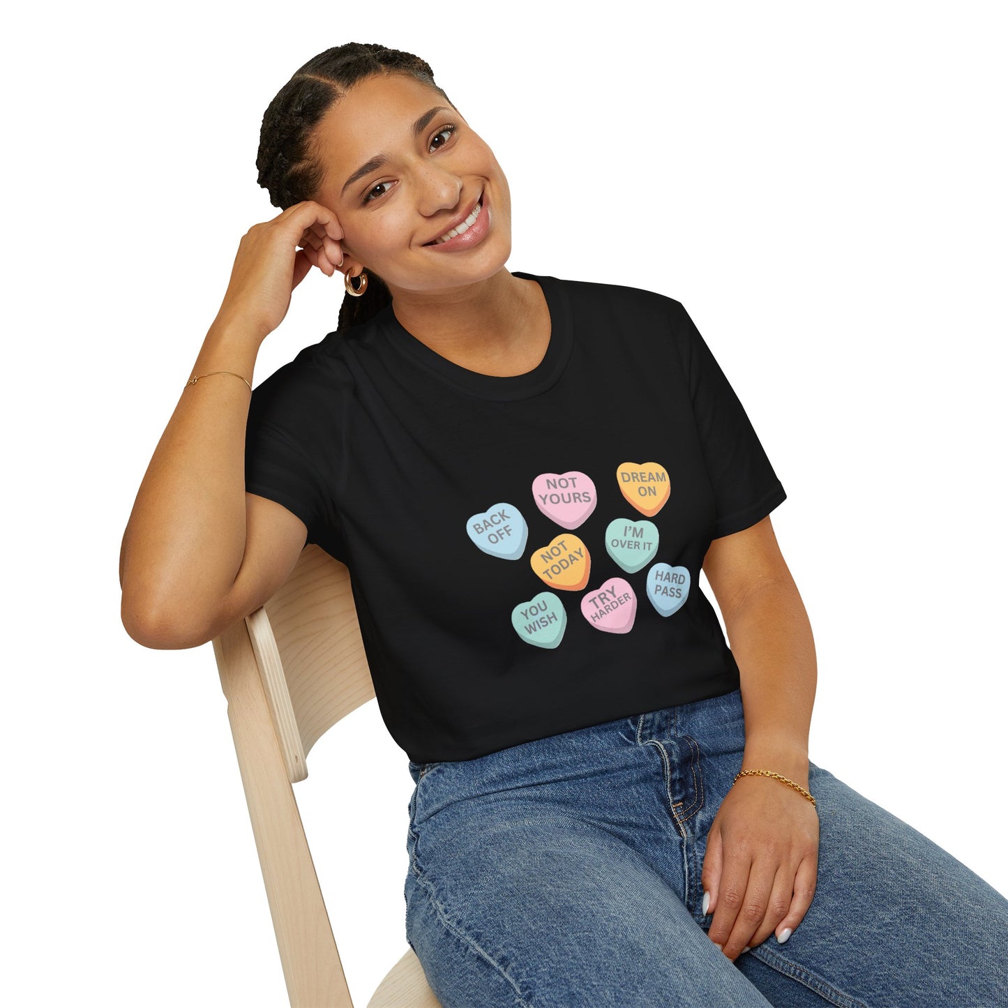 Person wearing a black t-shirt with colorful candy heart designs and text.