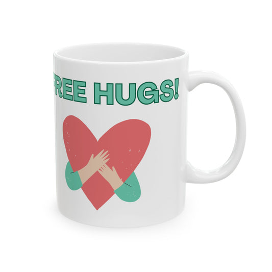White mug with a red heart and hands hugging design, and 'FREE HUGS!' text on a white background.