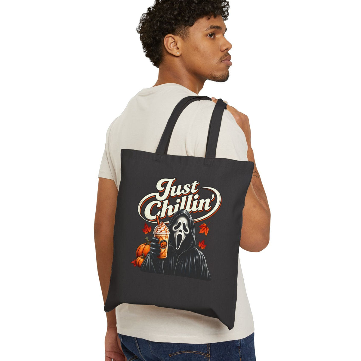 Man carrying a black tote bag with a design and text on a white background