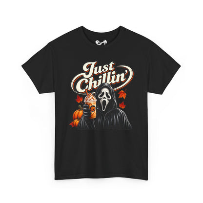 A black short-sleeve t-shirt with a graphic print featuring the Ghostface character from Scream holding an iced coffee, next to pumpkins and autumn leaves, with the text 'Just Chillin'' in white and orange.
