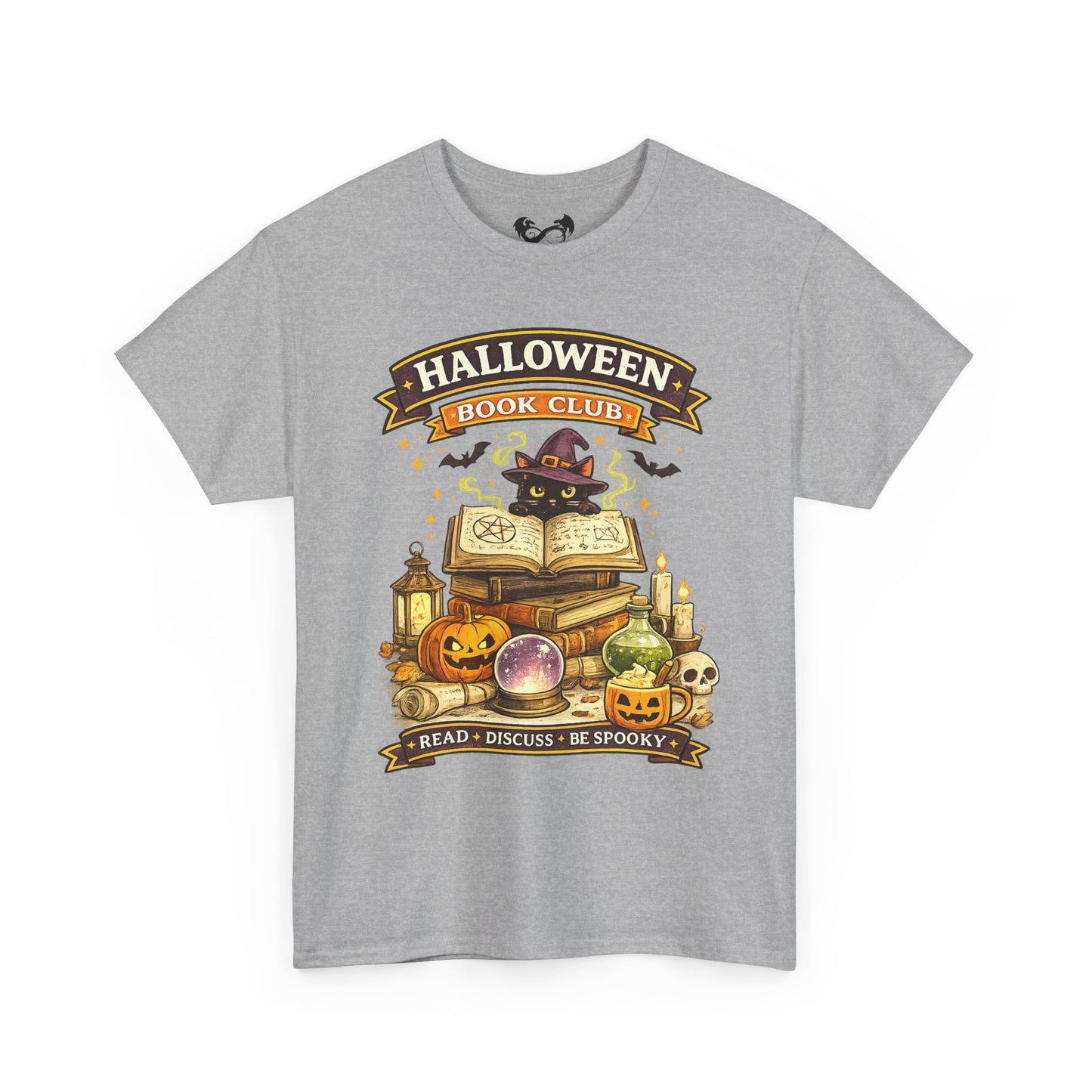 A heather gray short-sleeve crewneck t-shirt featuring a colorful graphic print on the front. The graphic displays a black cat wearing a witch hat surrounded by Halloween-themed items like pumpkins, a skull, an open book, and a cauldron, with banners reading 'HALLOWEEN BOOK CLUB' and 'READ • DISCUSS • BE SPOOKY'.