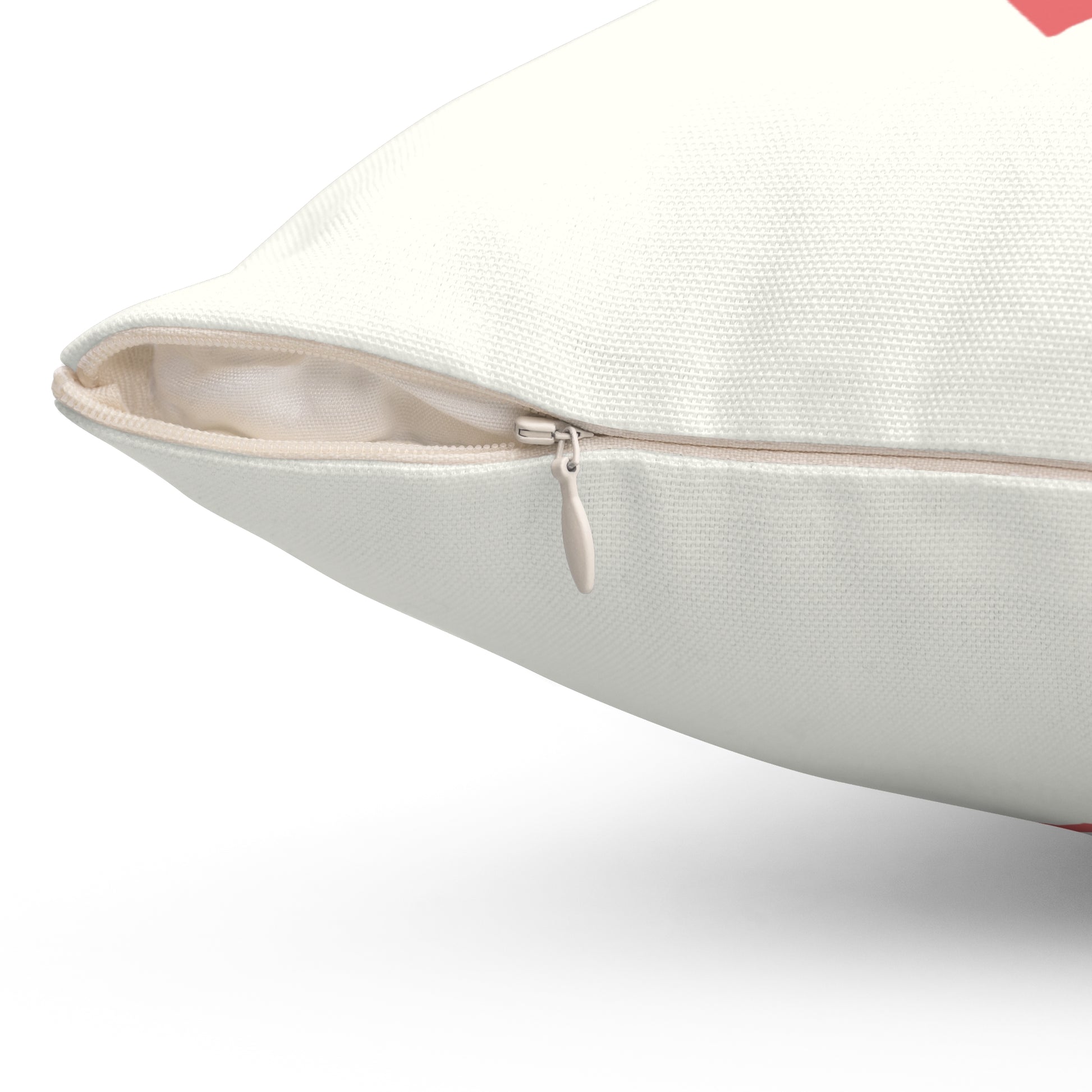 Close-up of a white pillow with a zipper on a white background