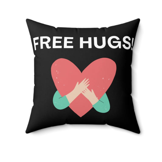 Black pillow with 'FREE HUGS!' text and heart design on a white background