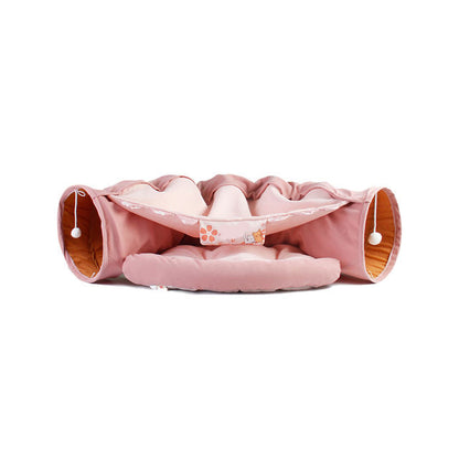Give your cat a cozy and playful retreat with this Foldable Cat Tunnel &amp; Bed. Designed for both entertainment and comfort, it easily folds for convenient storage or travel. Perfect for cats who love to hide, pounce, or relax, this versatile tunnel doubles as a soft bed, creating a safe space your feline friend will adore.