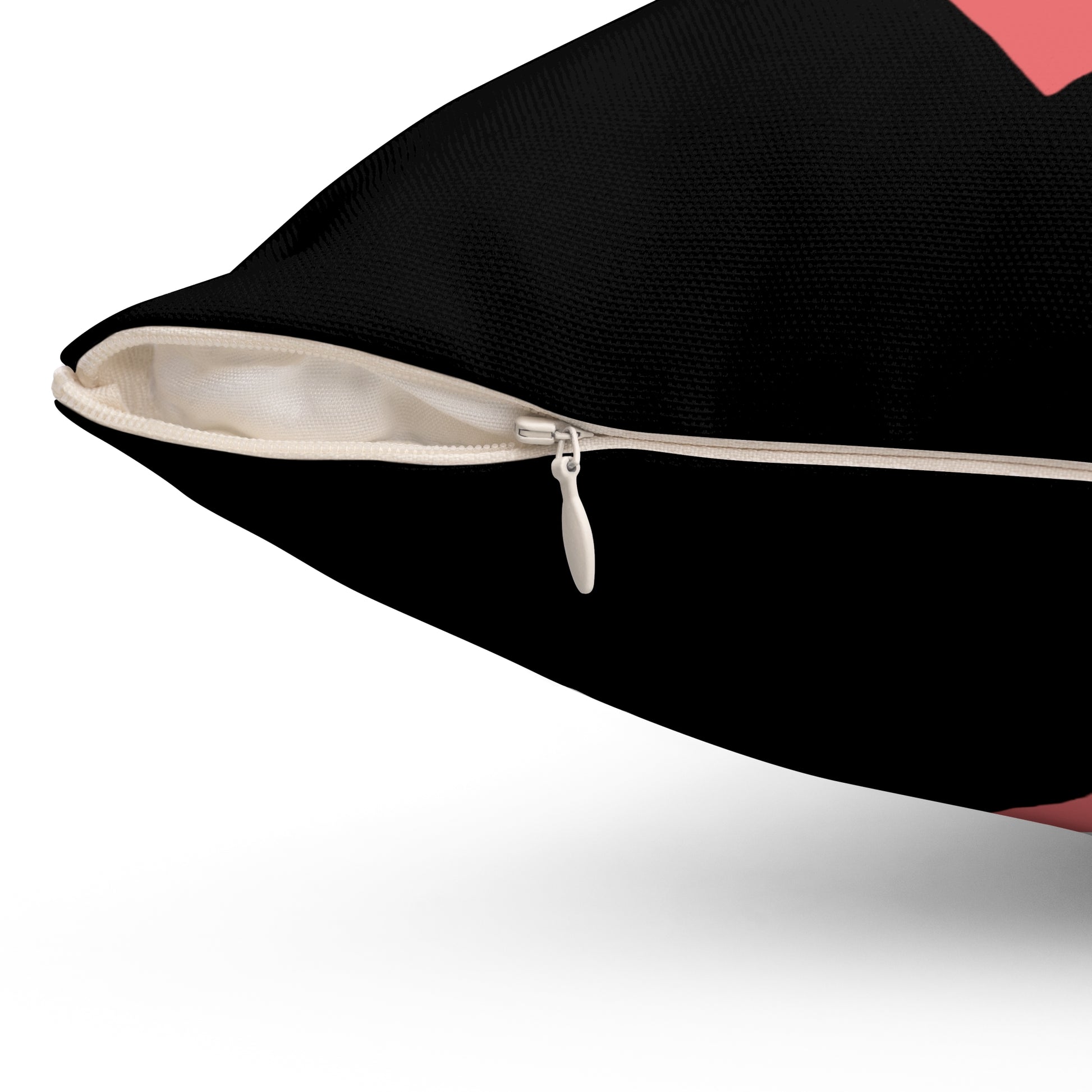 Close-up of a black pillow with a zipper on a white background