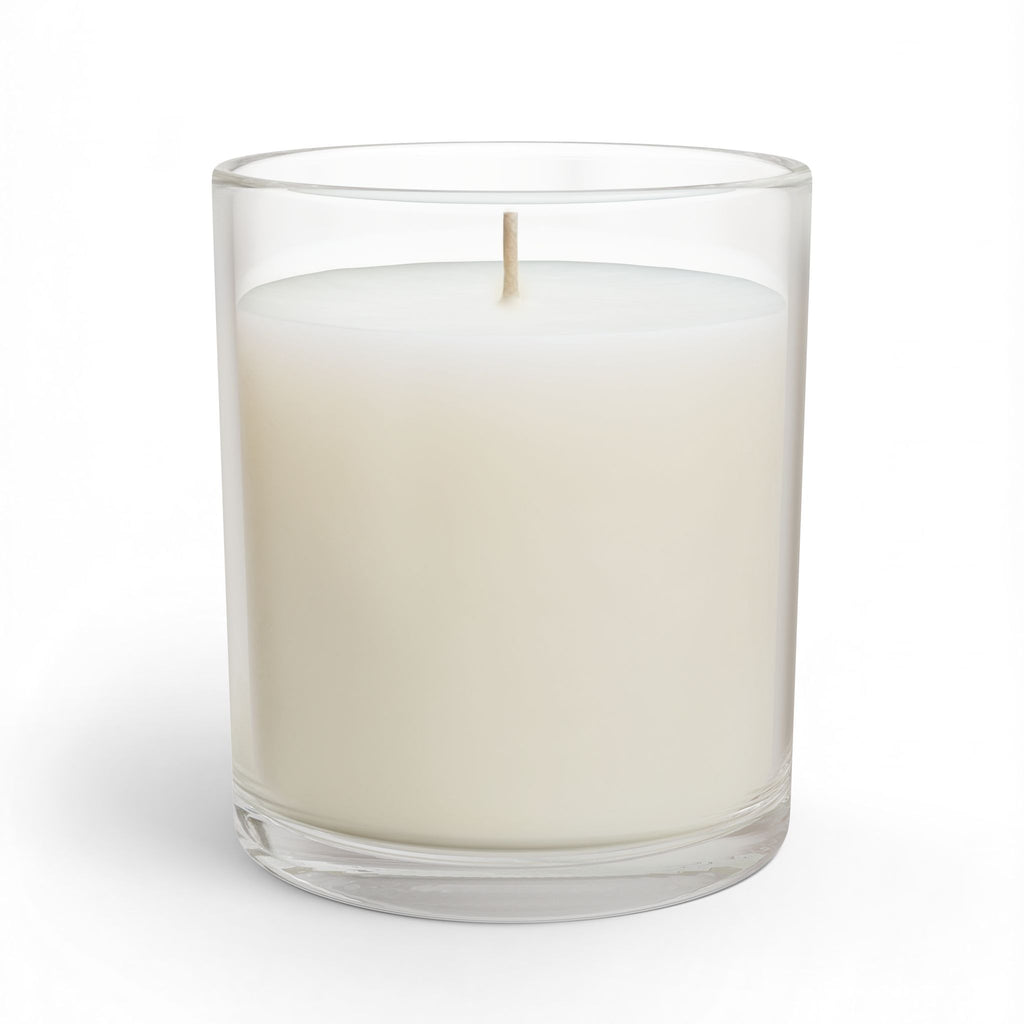 White candle in a clear glass container on a white background