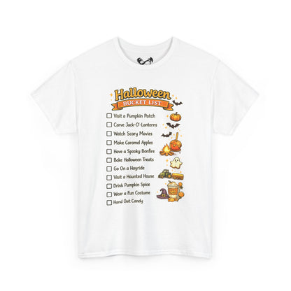 A white short-sleeve crewneck t-shirt featuring a 'Halloween Bucket List' graphic on the front. The graphic includes a checklist of spooky activities with illustrations of pumpkins, bats, a ghost, a haunted house, and a cauldron.