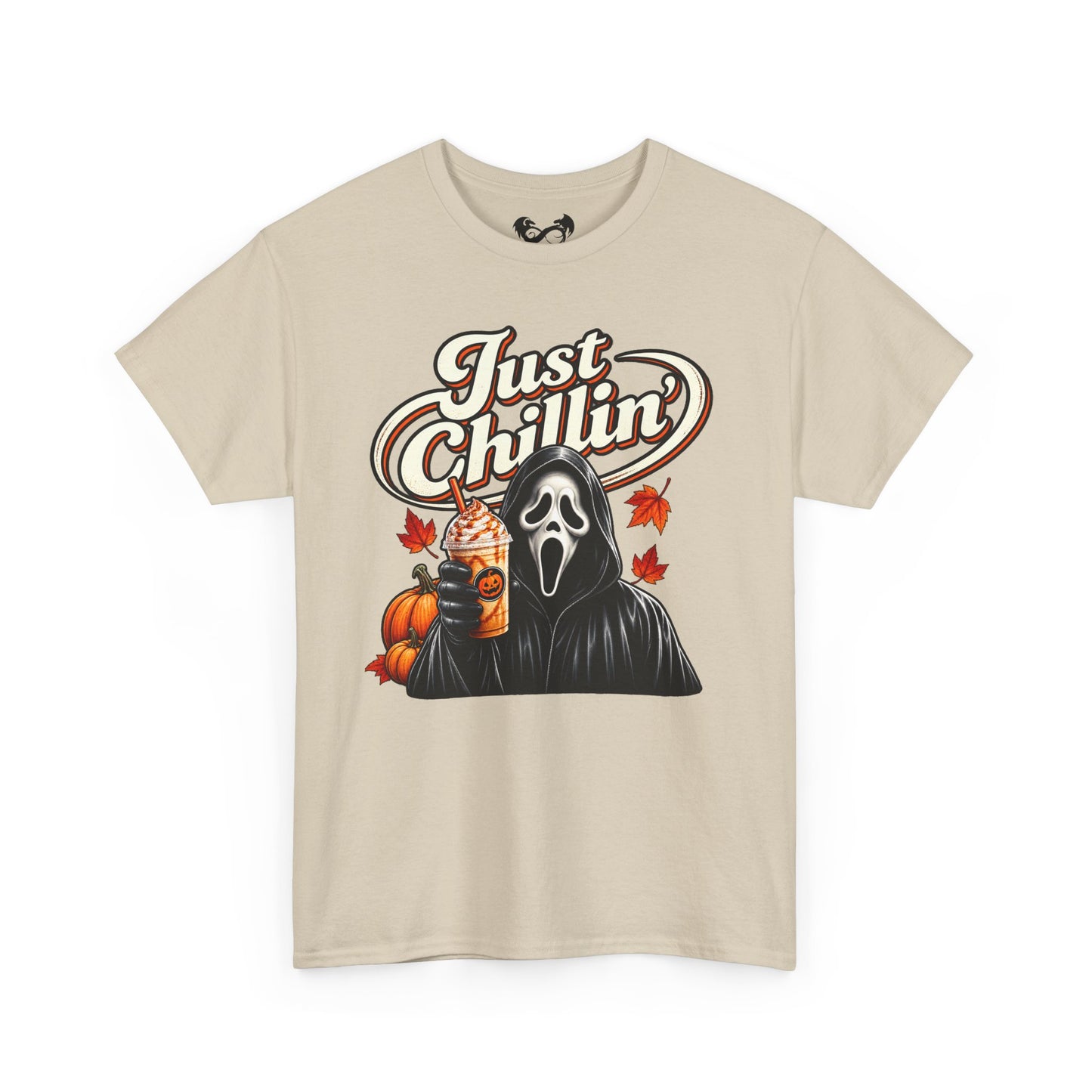 A beige short-sleeve crewneck t-shirt featuring a graphic print of Ghostface from Scream holding an iced coffee with pumpkin and maple leaf accents, under the text 'Just Chillin''.