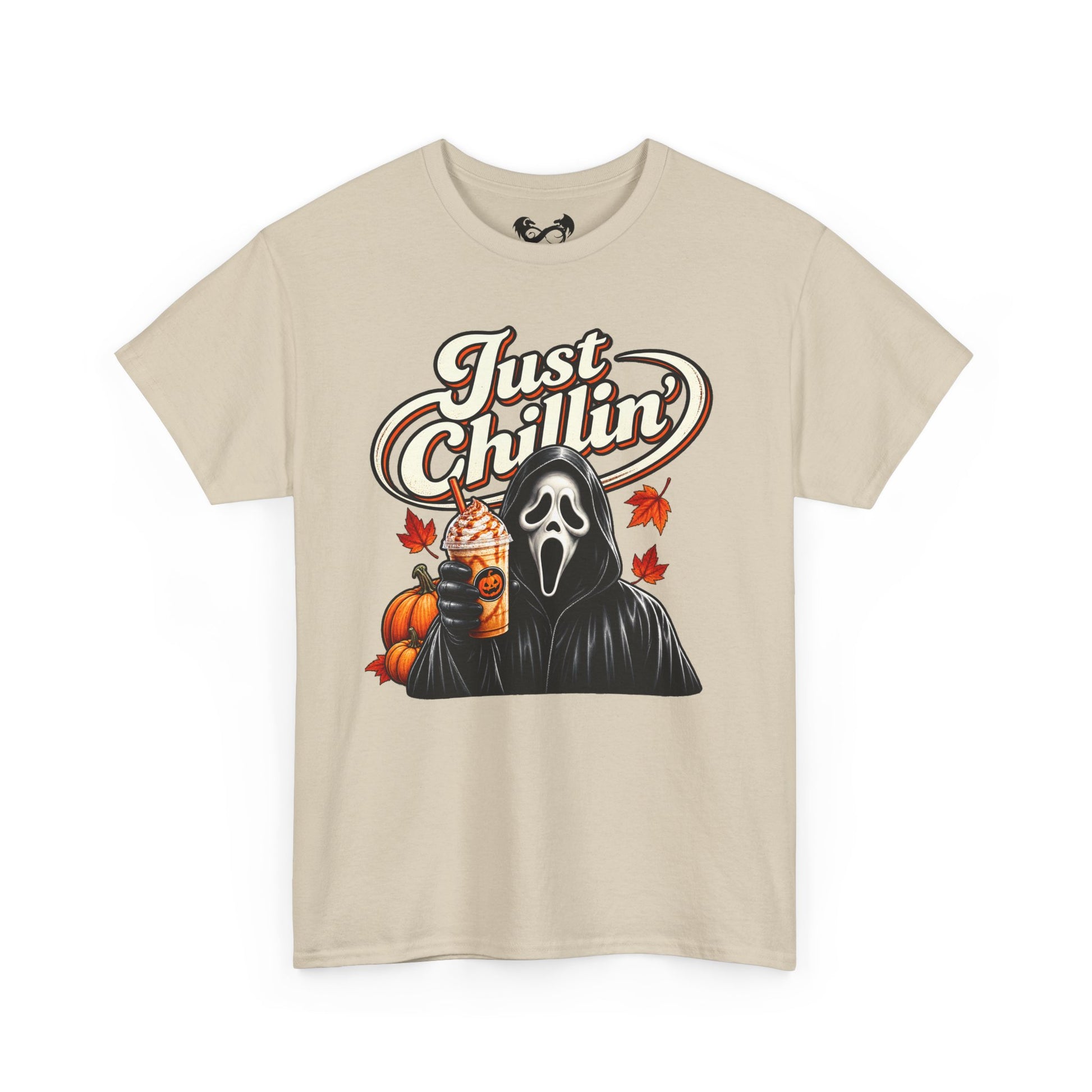 A beige short-sleeve crewneck t-shirt featuring a graphic print of Ghostface from Scream holding an iced coffee with pumpkin and maple leaf accents, under the text 'Just Chillin''.