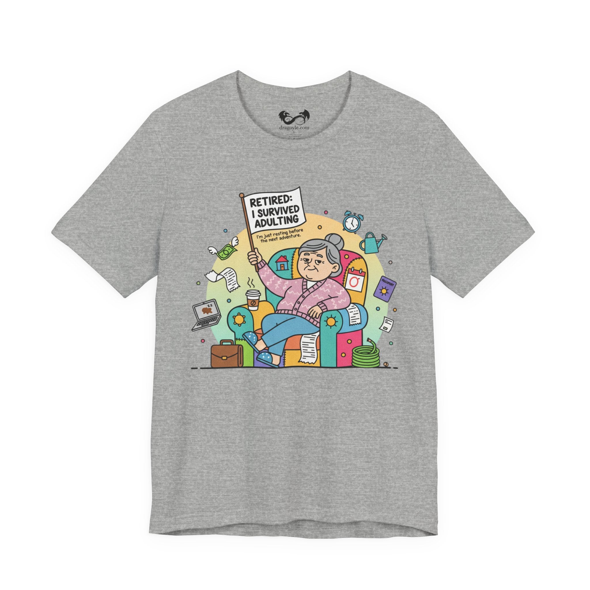 Gray t-shirt with a colorful graphic of an elderly woman holding a sign that says 'Retired: I survived adulting' on a white background.
