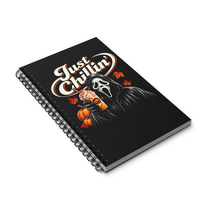 A black spiral notebook featuring a Ghostface-themed graphic with the text 'Just Chillin'', a ghost in a black hood holding a pumpkin, and orange autumn leaves, shown on a white background.