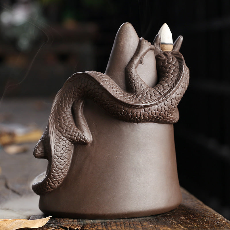 This handmade Purple Sand Dragon Backflow Incense Burner is the perfect addition to any room. With its intricate design and durable construction, you'll be enchanted by the mystical smoke that cascades down the figure.