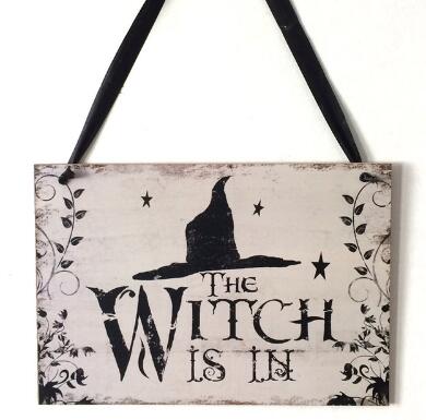 Fly away to the dark side of Halloween décor with this enchanting "The Witch Is In" rustic wooden plaque! This quirky decoration is sure to spark conversations and cast a spell over trick-or-treaters. Come, come! The Witch Is In!  On the back side it says "Out of Candy".