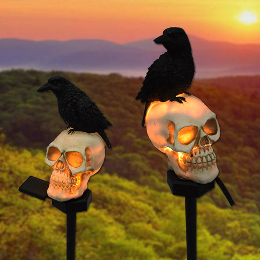 Illuminate your outdoor space with the daring Raven on Skull Solar Yard Lighting. This striking light features a raven perched atop a skull, casting an eerie glow powered by solar energy.
