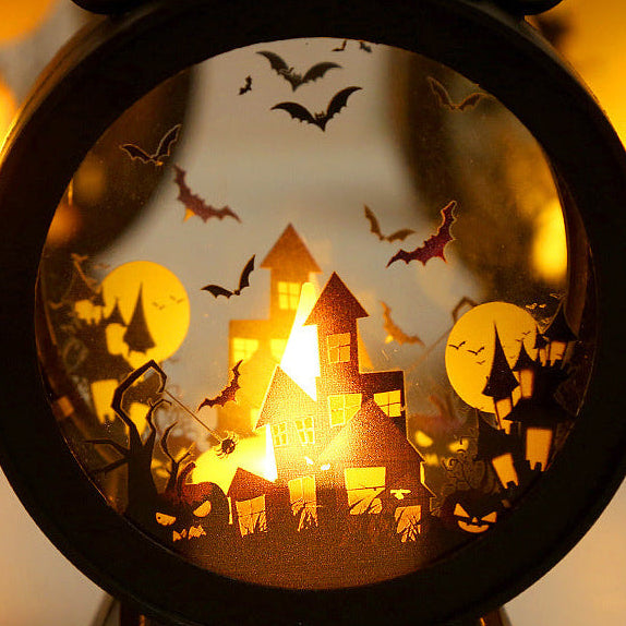 Halloween-themed decorative light with haunted house and bats design.
