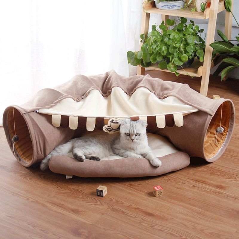 Give your cat a cozy and playful retreat with this Foldable Cat Tunnel &amp; Bed. Designed for both entertainment and comfort, it easily folds for convenient storage or travel. Perfect for cats who love to hide, pounce, or relax, this versatile tunnel doubles as a soft bed, creating a safe space your feline friend will adore.