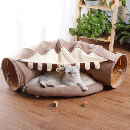 Give your cat a cozy and playful retreat with this Foldable Cat Tunnel &amp; Bed. Designed for both entertainment and comfort, it easily folds for convenient storage or travel. Perfect for cats who love to hide, pounce, or relax, this versatile tunnel doubles as a soft bed, creating a safe space your feline friend will adore.