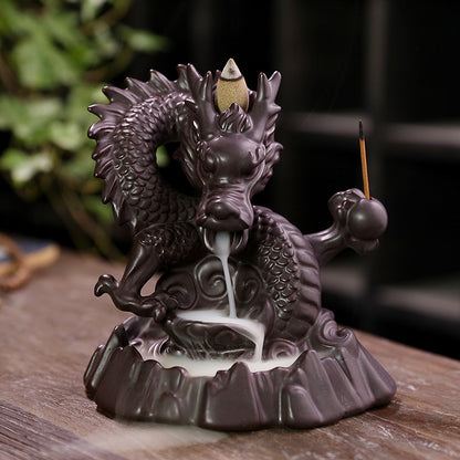 Elevate your home decor with our Ceramic Chinese Dragon Backflow Incense Burner. Watch as the intricately designed dragon releases a soothing flow of smoke, creating a serene atmosphere. Handcrafted from ceramic, this burner adds a touch of elegance and tradition to any space. Perfect for relaxation and meditation.