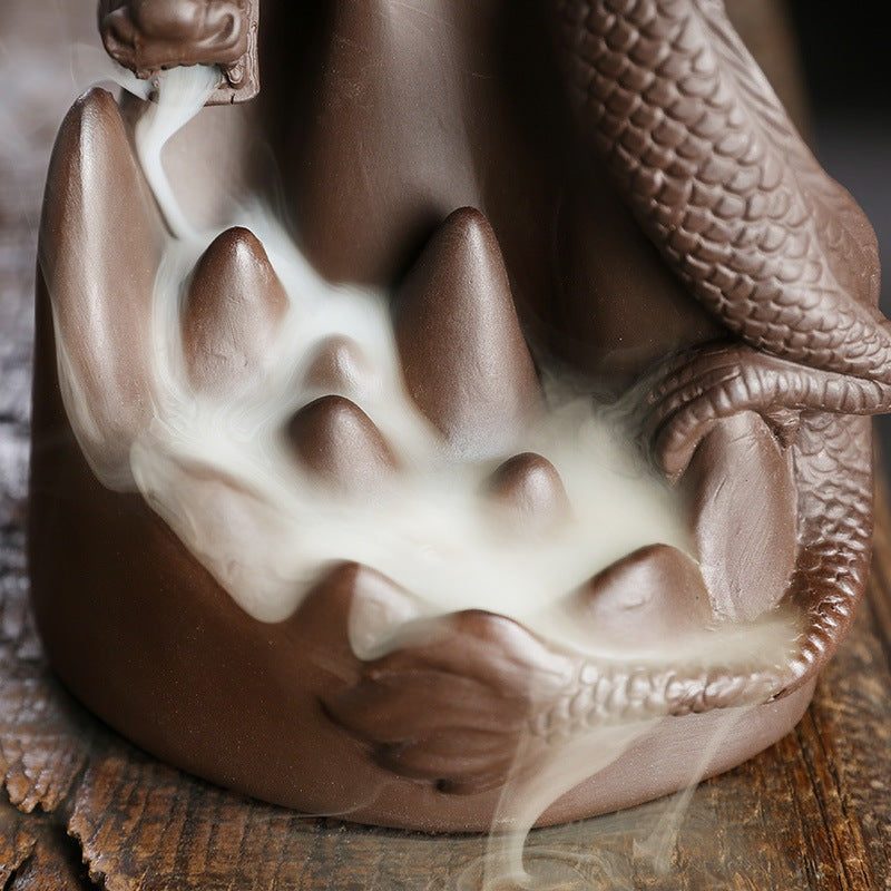 This handmade Purple Sand Dragon Backflow Incense Burner is the perfect addition to any room. With its intricate design and durable construction, you'll be enchanted by the mystical smoke that cascades down the figure.