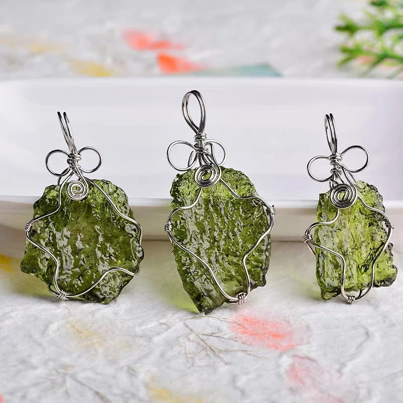 Discover the unique beauty of natural green moldavite with our stunning necklace. Created by the natural force of meteorite impact, this necklace boasts a one-of-a-kind natural shape and impressive dark green hue. Add a touch of rare elegance to your jewelry collection with this incredible piece.