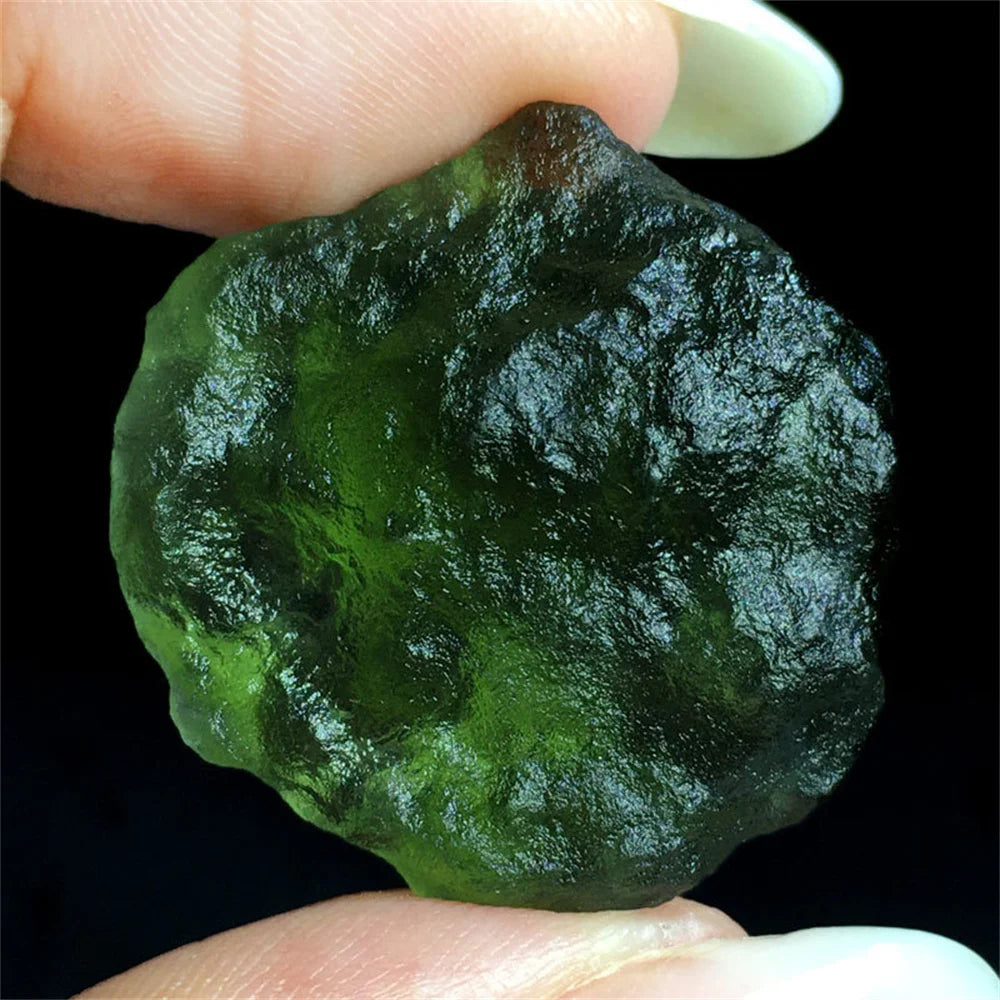 As an expert in the crystal industry, we present to you the Natural Rough Cut Green Moldavite Energy Crystal. Sourced from the Czech Republic, this crystal is known for its powerful energy and potential to enhance mental clarity and spiritual growth. Each crystal is unique with natural rough cuts, making it a one-of-a-kind addition to any collection.