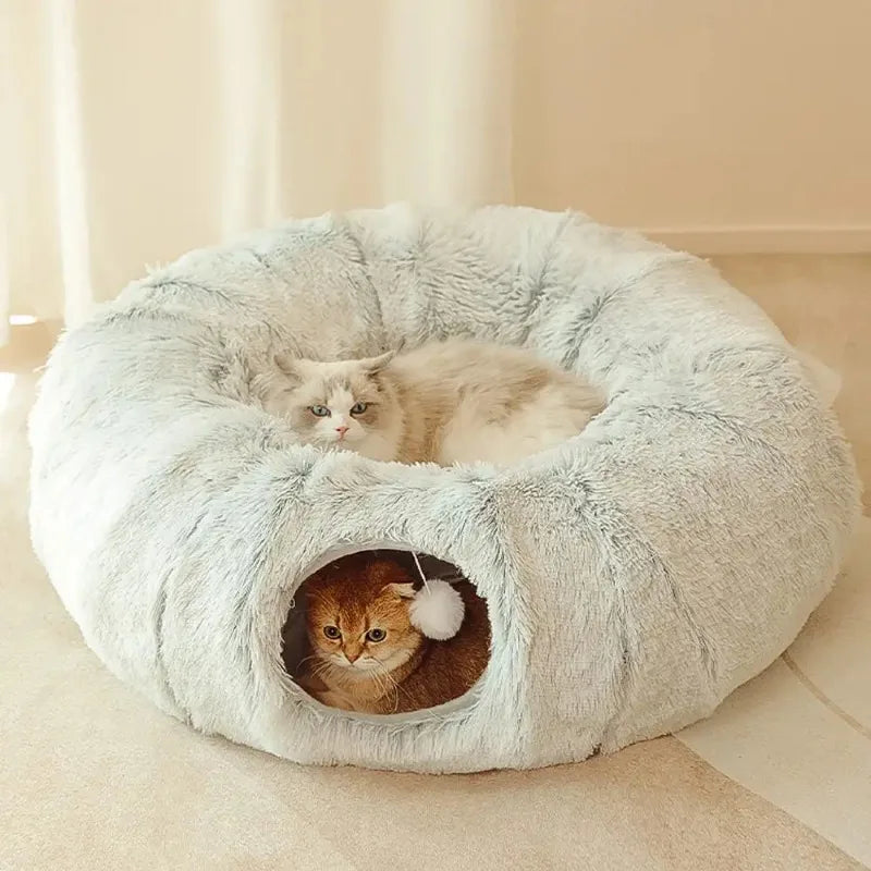 Indulge your feline friend with our Fluffy Donut Cat Bed featuring a cozy tunnel for ultimate comfort. Let your cat cuddle up in the soft and fluffy material, providing a sense of security and warmth. Perfect for those lazy days or a restful slumber. Pamper your cat with this delightful bed!