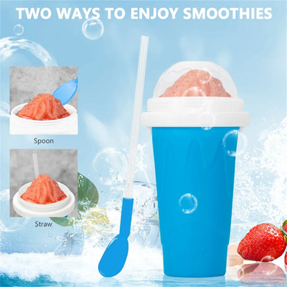 Blue smoothie cup with spoon and straw, surrounded by ice cubes and strawberries on a blue background.