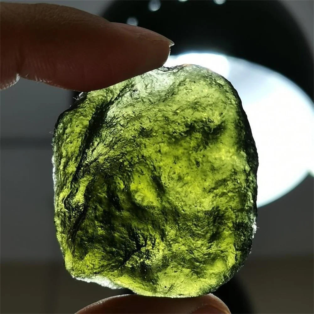 As an expert in the crystal industry, we present to you the Natural Rough Cut Green Moldavite Energy Crystal. Sourced from the Czech Republic, this crystal is known for its powerful energy and potential to enhance mental clarity and spiritual growth. Each crystal is unique with natural rough cuts, making it a one-of-a-kind addition to any collection.