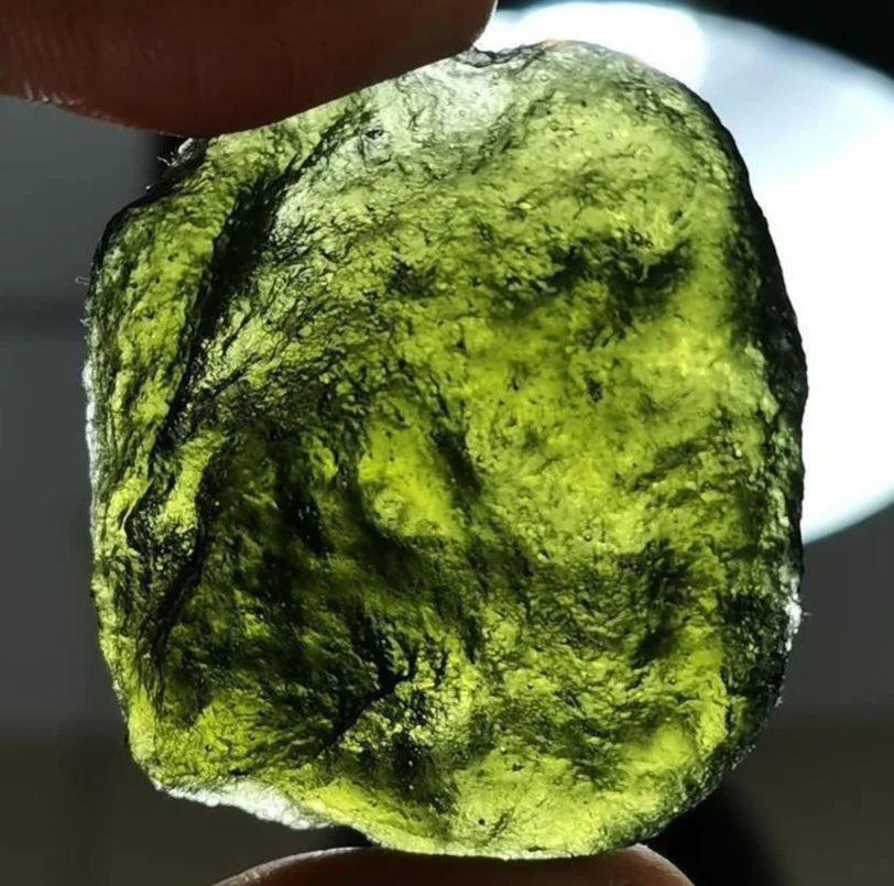 As an expert in the crystal industry, we present to you the Natural Rough Cut Green Moldavite Energy Crystal. Sourced from the Czech Republic, this crystal is known for its powerful energy and potential to enhance mental clarity and spiritual growth. Each crystal is unique with natural rough cuts, making it a one-of-a-kind addition to any collection.