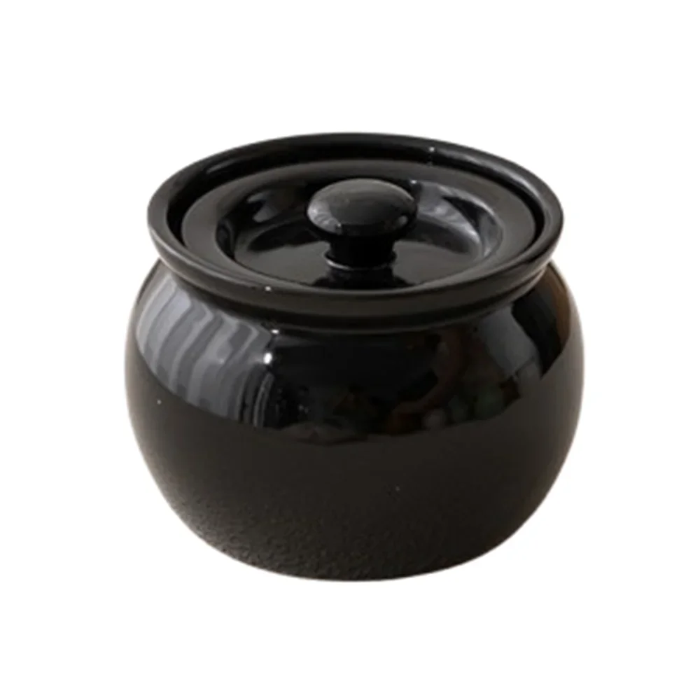 Black ceramic pot with lid on a white background