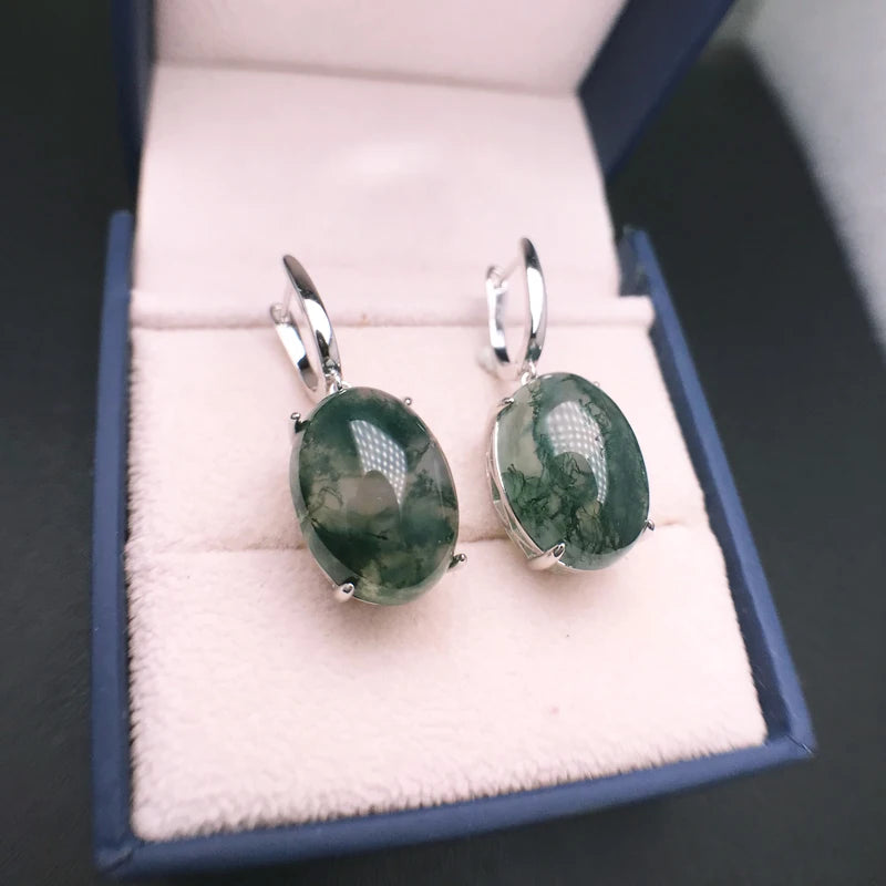 Green stone earrings in a jewelry box